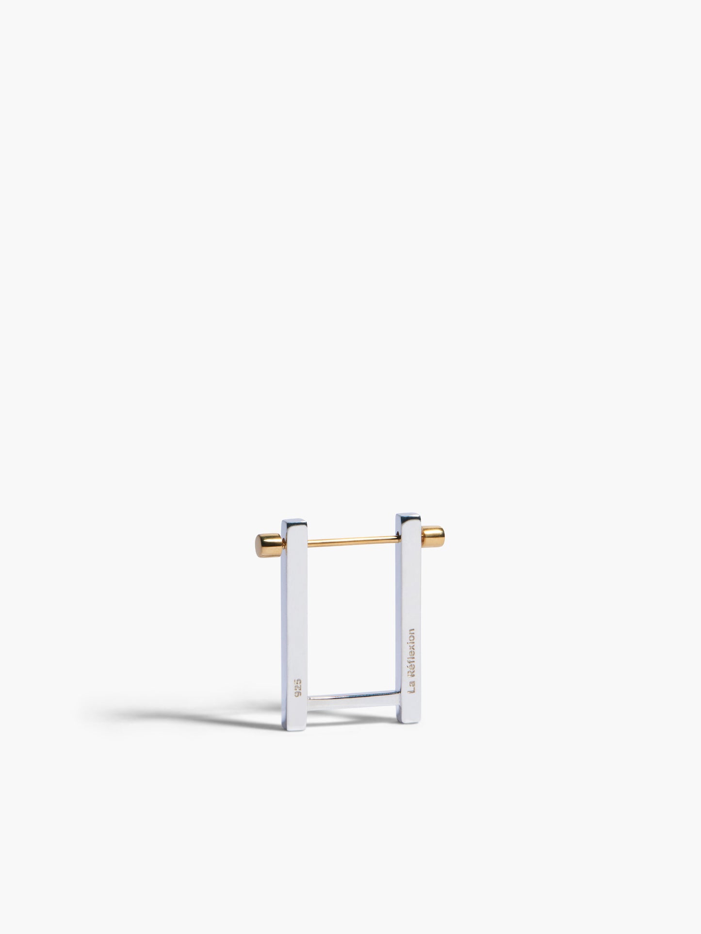 Gold and clear square-shaped earring on a white background