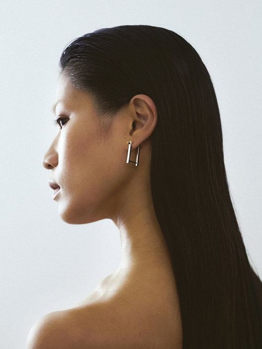 women wearing 18k yellow gold screw piercing earrings made in france