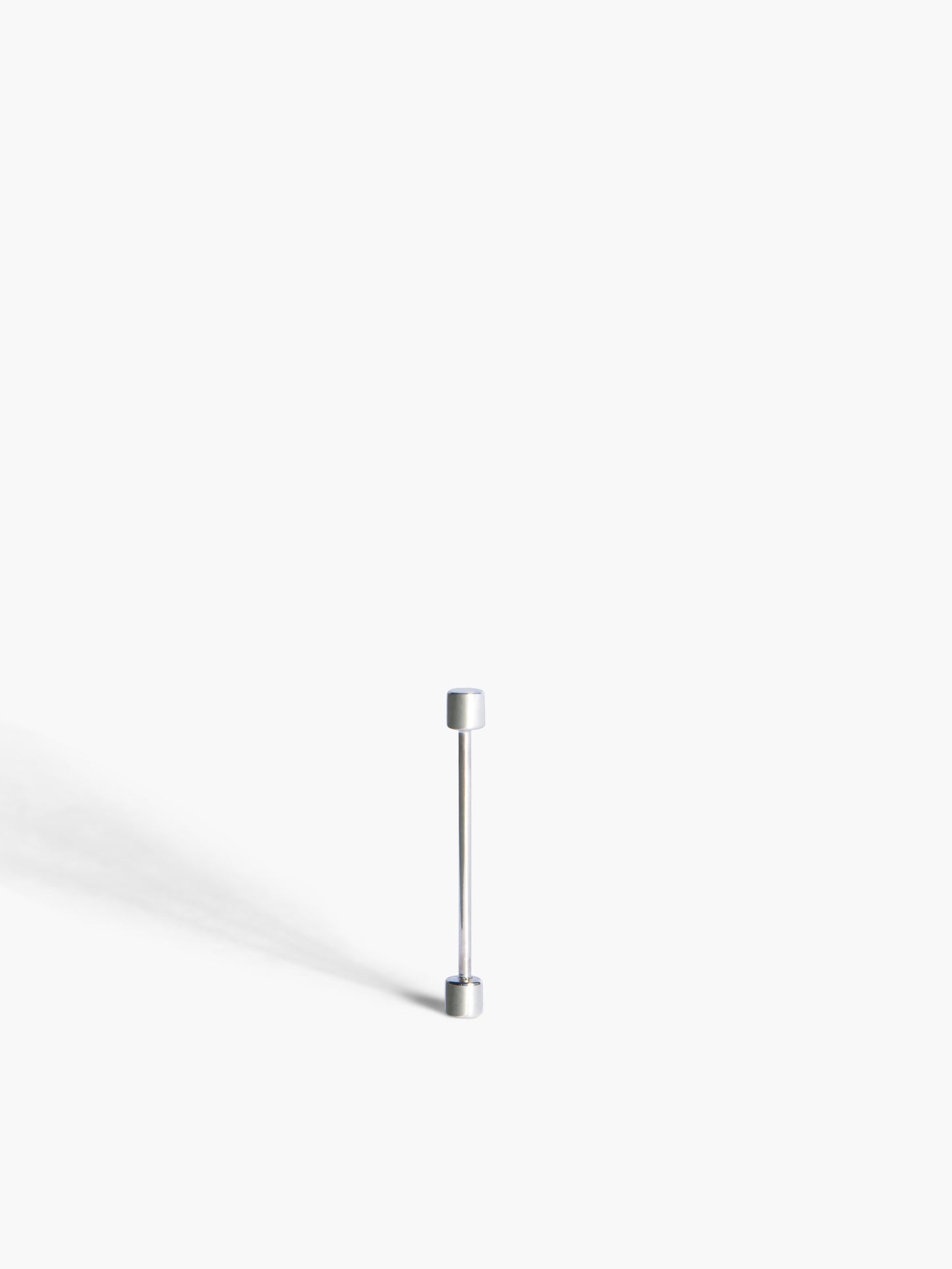 White gold screw piercing earring on a white background