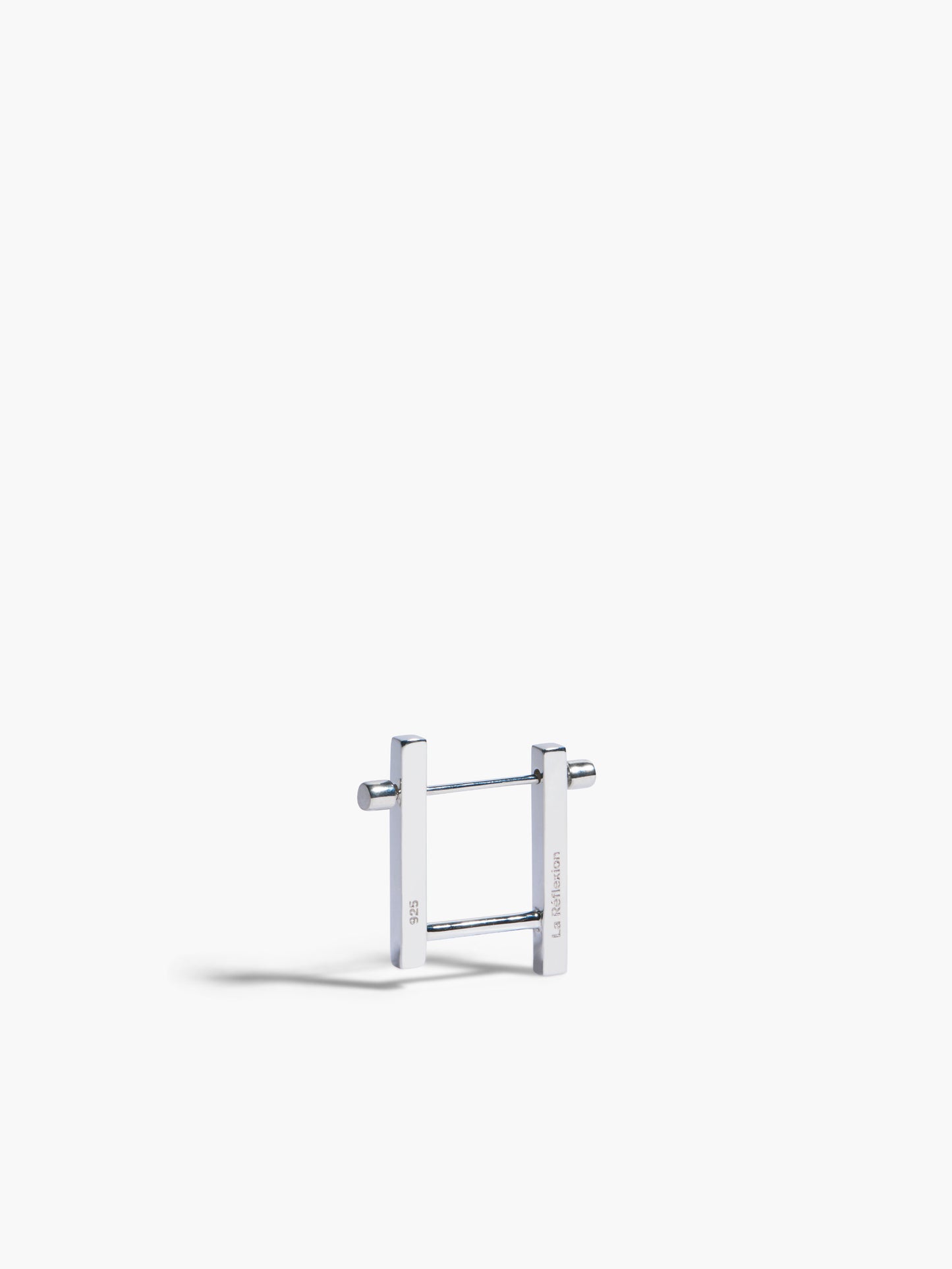 Silver earring on a white background