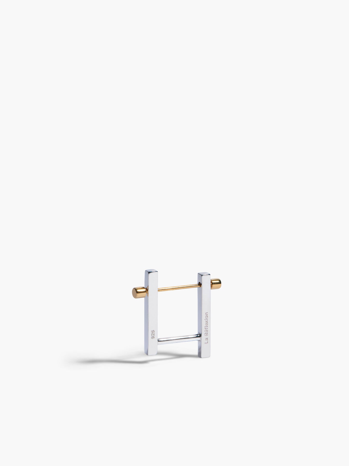 Gold and silver earring on a white background