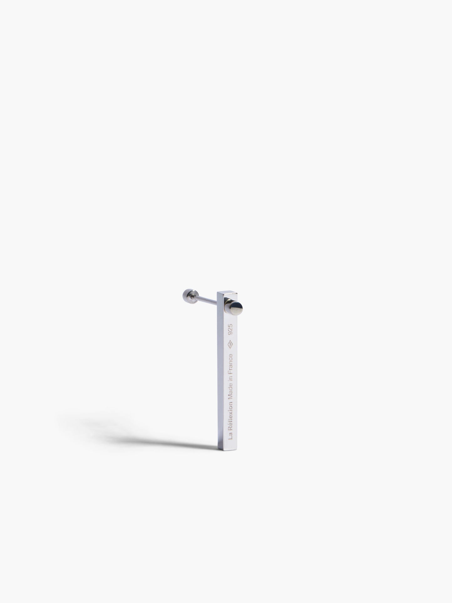 Silver gold and silver bar earring on a white background