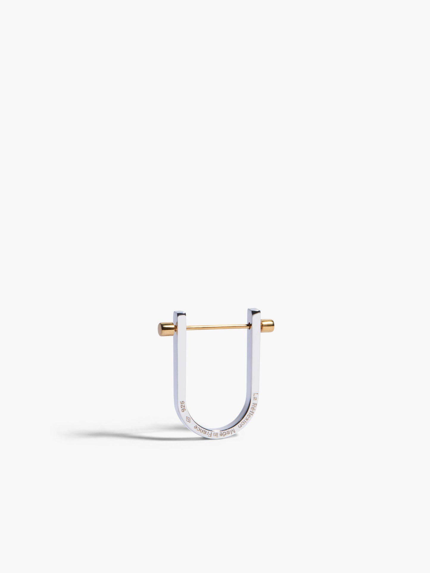 Silver and gold U-shaped earring on a white background