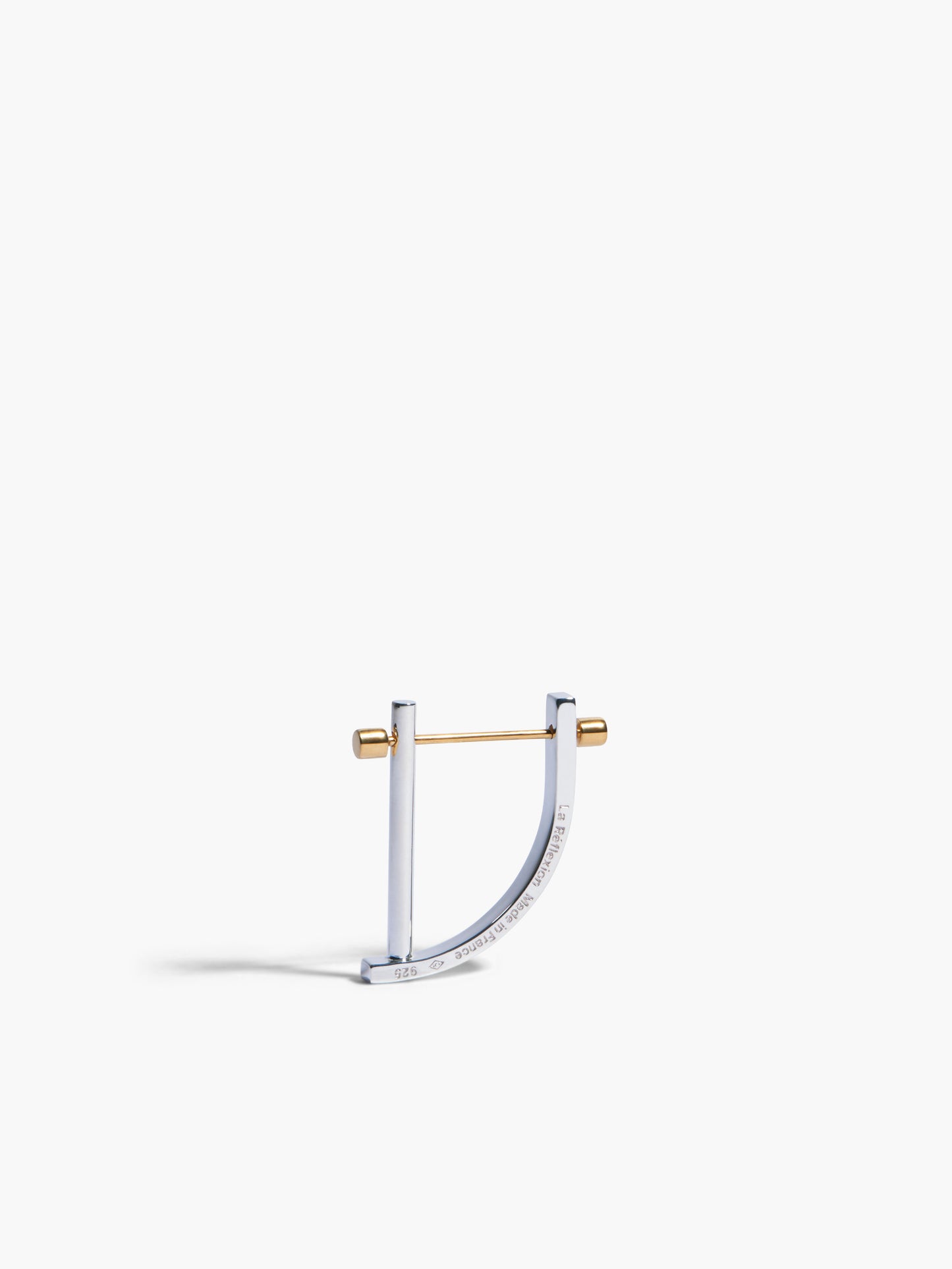 Gold and silver earring on a white background