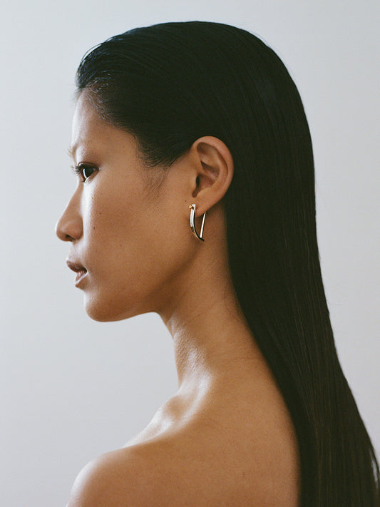 women wearing 18k yellow gold circle screw piercing earring made in france