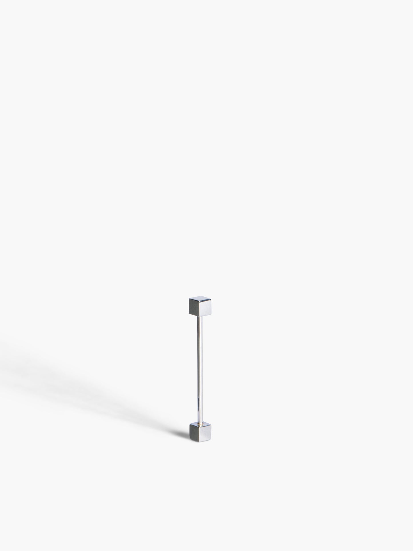 a gold bar earring on a white background