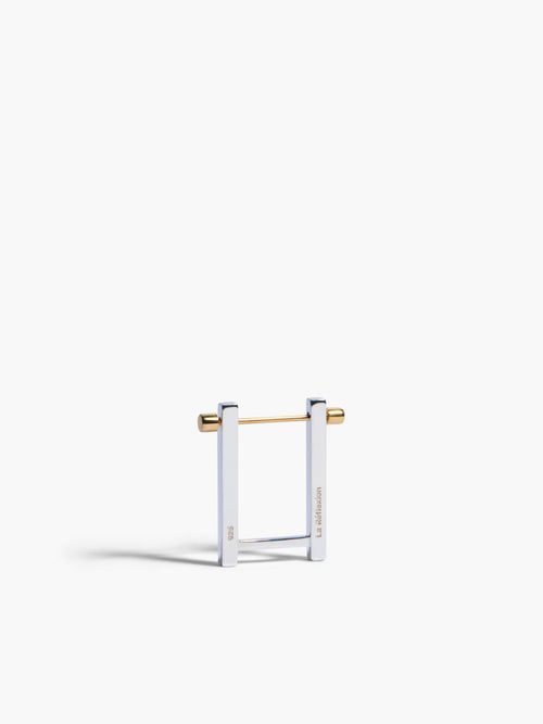 Gold and clear square-shaped earring on a white background