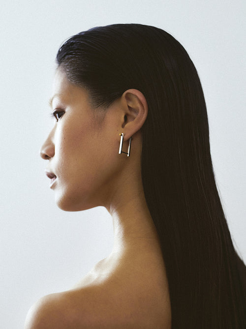 women wearing 18k yellow gold screw piercing earrings made in france