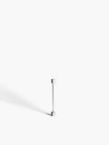 White gold screw piercing earring on a white background