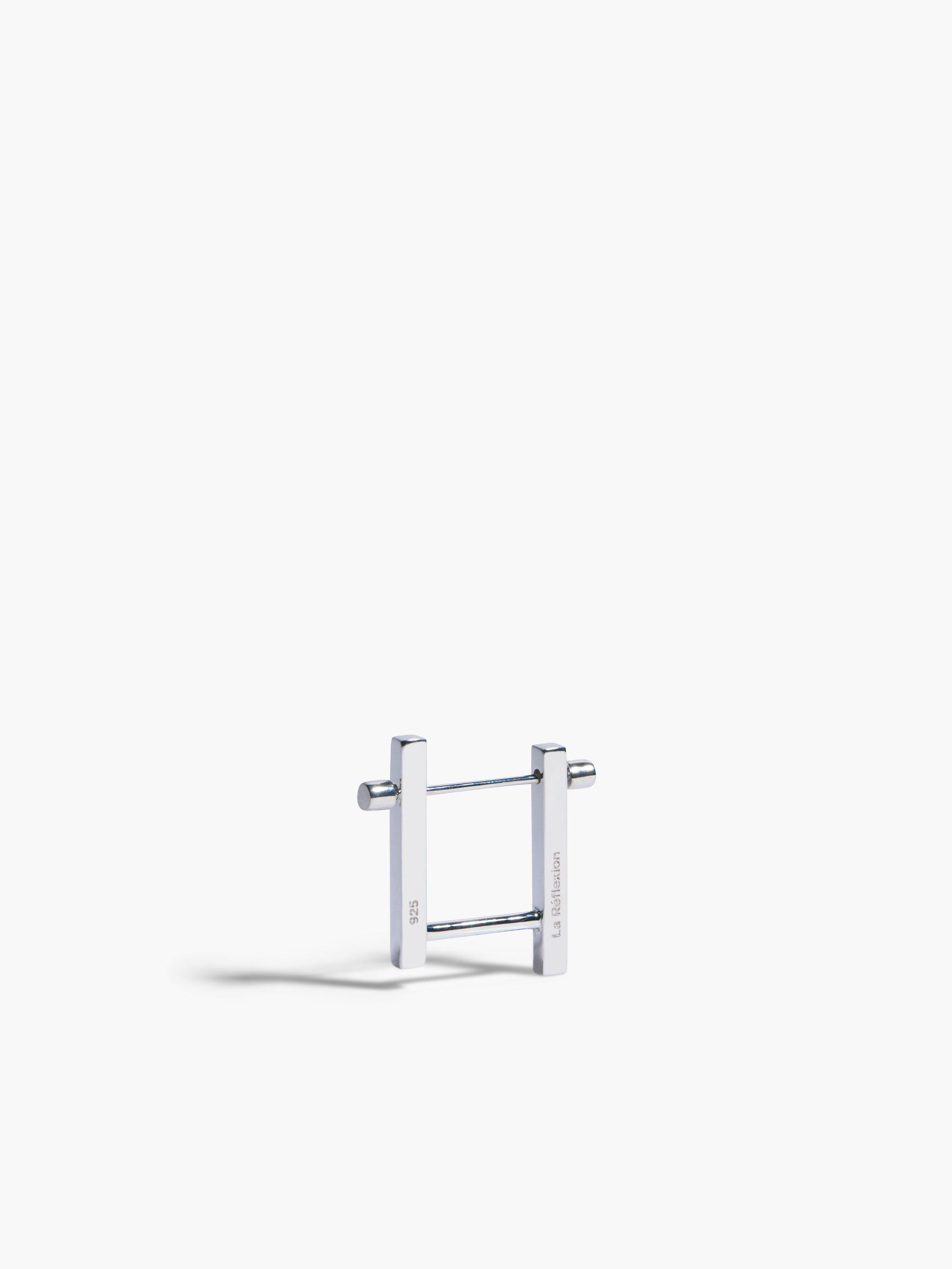 Silver earring on a white background