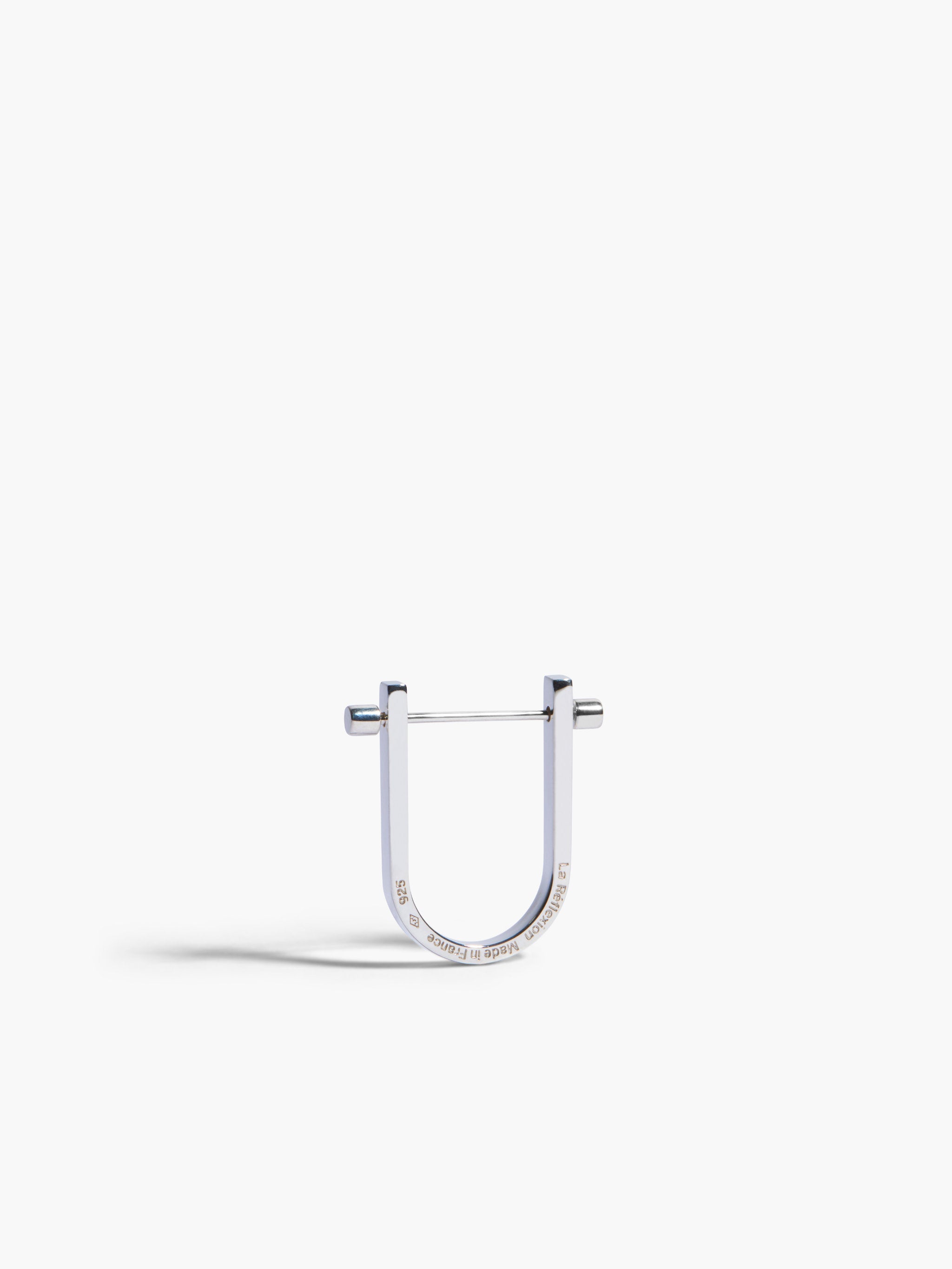 Silver U-shaped earring on a white background