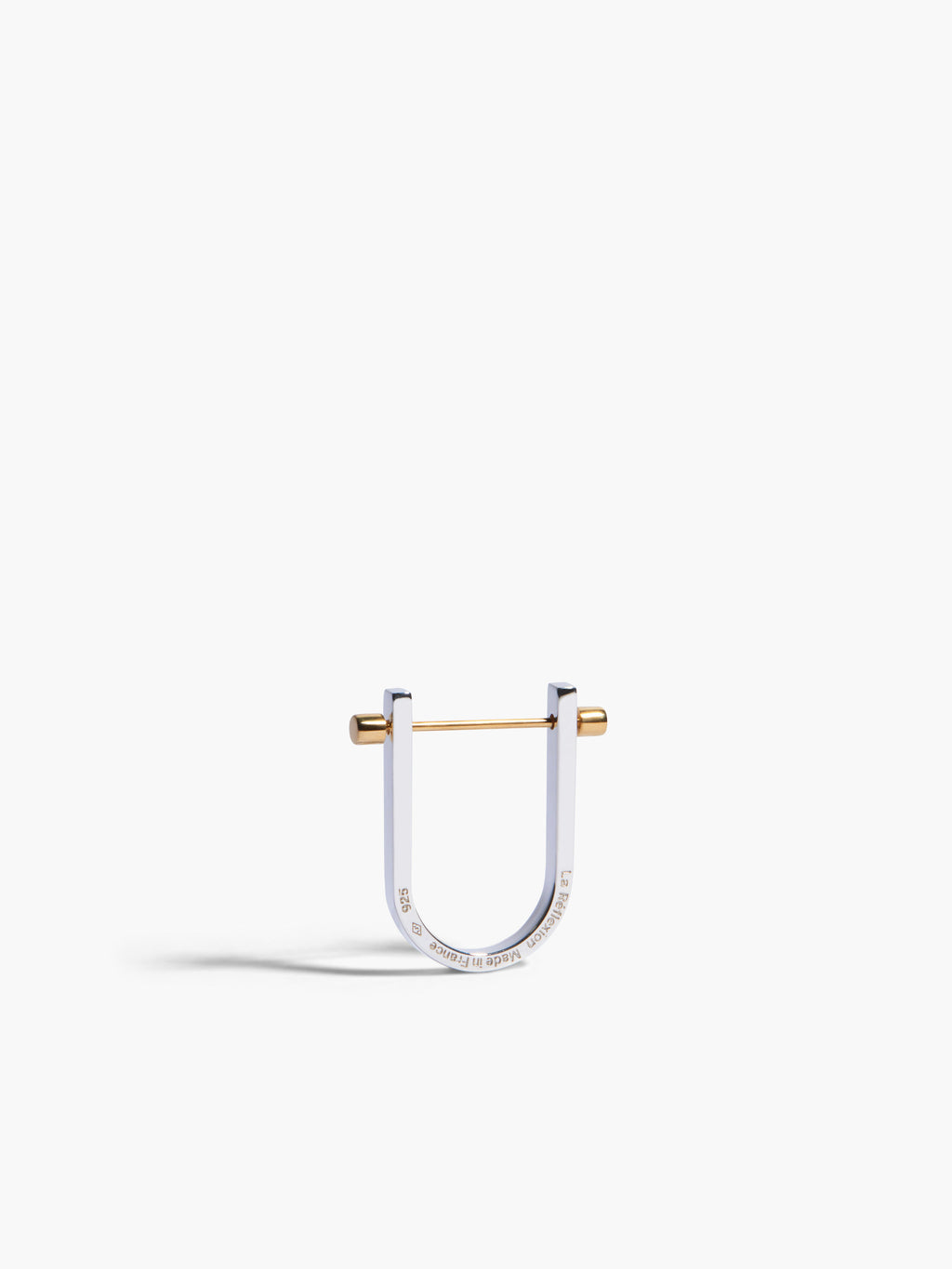 Silver and gold U-shaped earring on a white background