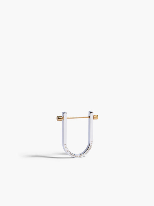 Silver and gold U-shaped earring on a white background